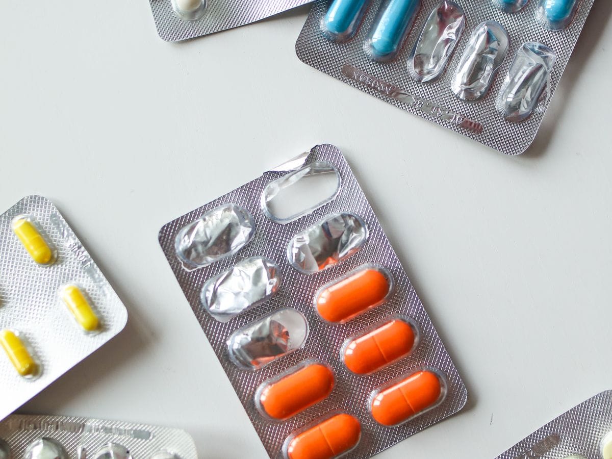 Blister packs of tablets laid out on a pale surface